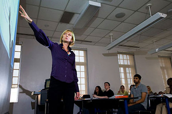 female standing at front of class teaching