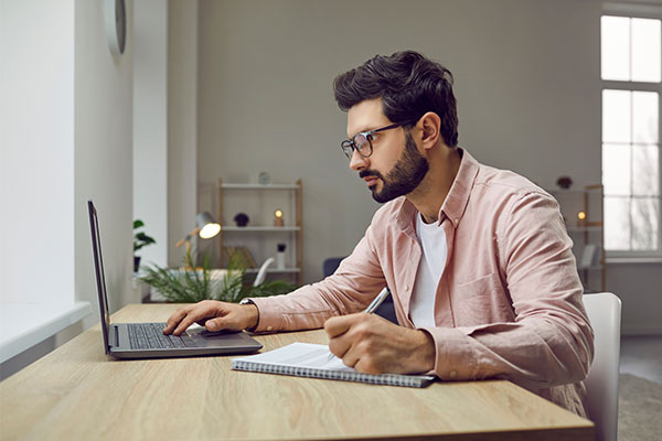 ide view shot of young man wearing glasses using laptop