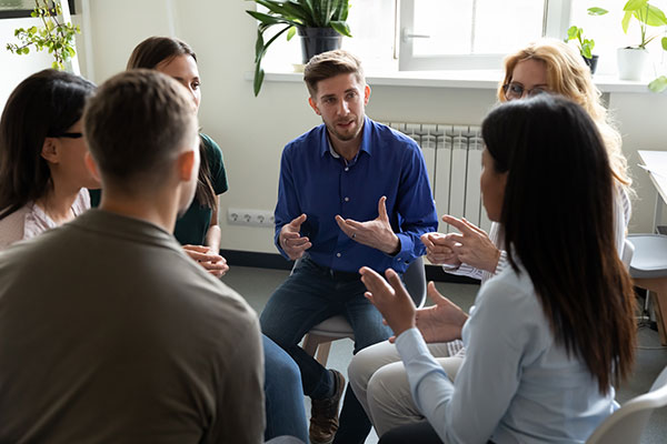Diverse workgroup sitting in a circle talking