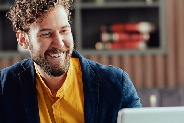 Person smiling at laptop