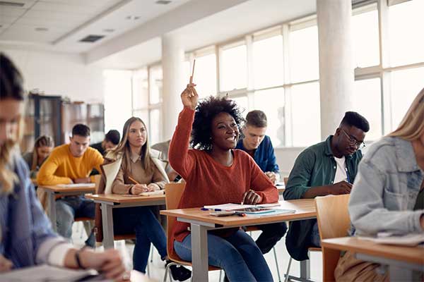 Person in classroom raising their hand