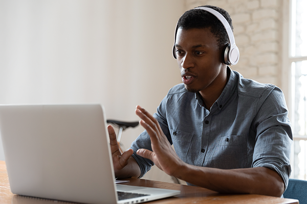 Person using laptop with headphones