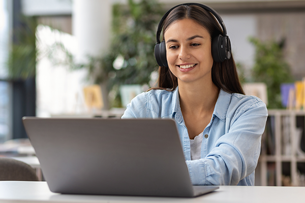 Person using laptop with headphones