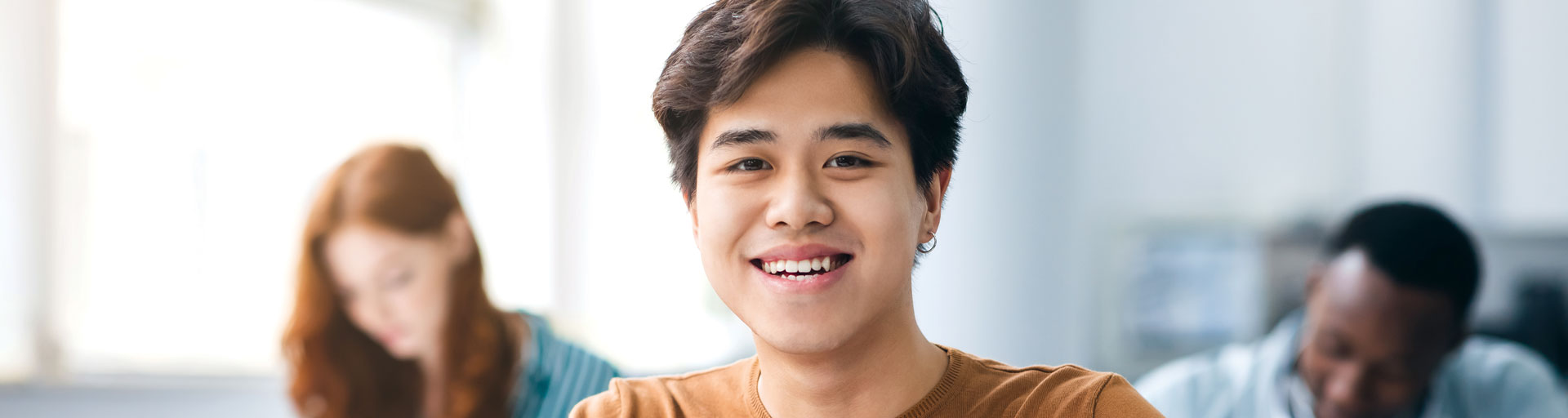 Student in classroom smiling