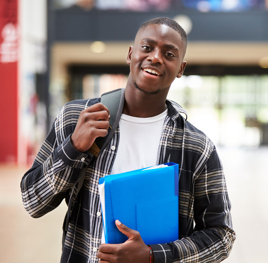 Student carrying backpack and binder